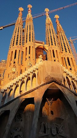 La fotografía muestra cuatro torres altas frente a la Sagrada Familia.