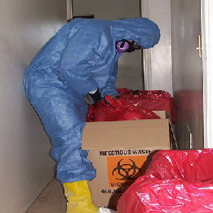 Imagen de la caja de desechos de riesgo biológico y la persona en el EPP
