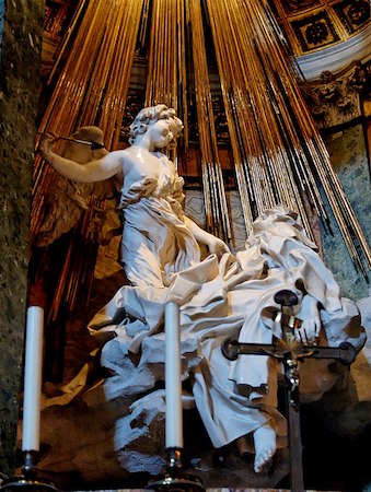Una fotografía del Éxtasis de Santa Teresa, una estatua de mármol de una mujer y un ángel.