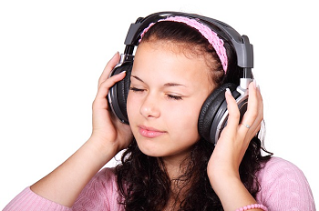 Chica con los ojos cerrados escuchando auriculares
