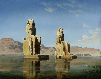 Imagen en color de dos grandes estatuas de piedra que representan a un faraón egipcio.