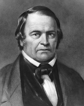 Un retrato en blanco y negro de William Miller, un hombre de cabello oscuro y corbata.